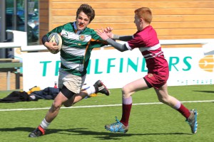 Eighth grader Russell Cornelius sprints down the line to avoid a tackle. Russell is using his free arm to help protect himself from being tackled. This was in a game for his club, Ealing Trailfinders against Ruislip last January (photo Courtesy Russell Cornelius).
