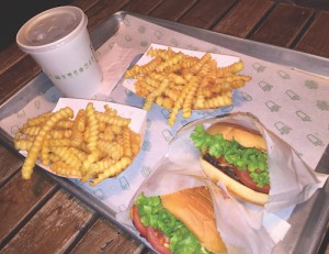Shake Shack burgers are available with free lettuce and tomato toppings. Most burger toppings are free except for extra cheese, bacon, or Shack Sauce. Shake Shack’s signature Crinkle Cut Fries are available with their blended cheddar cheese sauce as well as plain (photo by Grace Kelman).