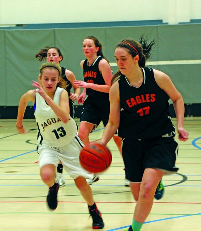 Lindsay Harris drives the ball down the court as she intercepted a pass from an opponent. This was during a home game against ACS Egham on December 15, and the Eagles won 42-23.(Photo by Cloe Tchelikidi)