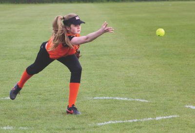 Eighth-grader Ava Crawford delivers a pitch on May 17. This was during a game against ACS Cobham where the team won 8-2 (photo by Cloe Tchelikidi).